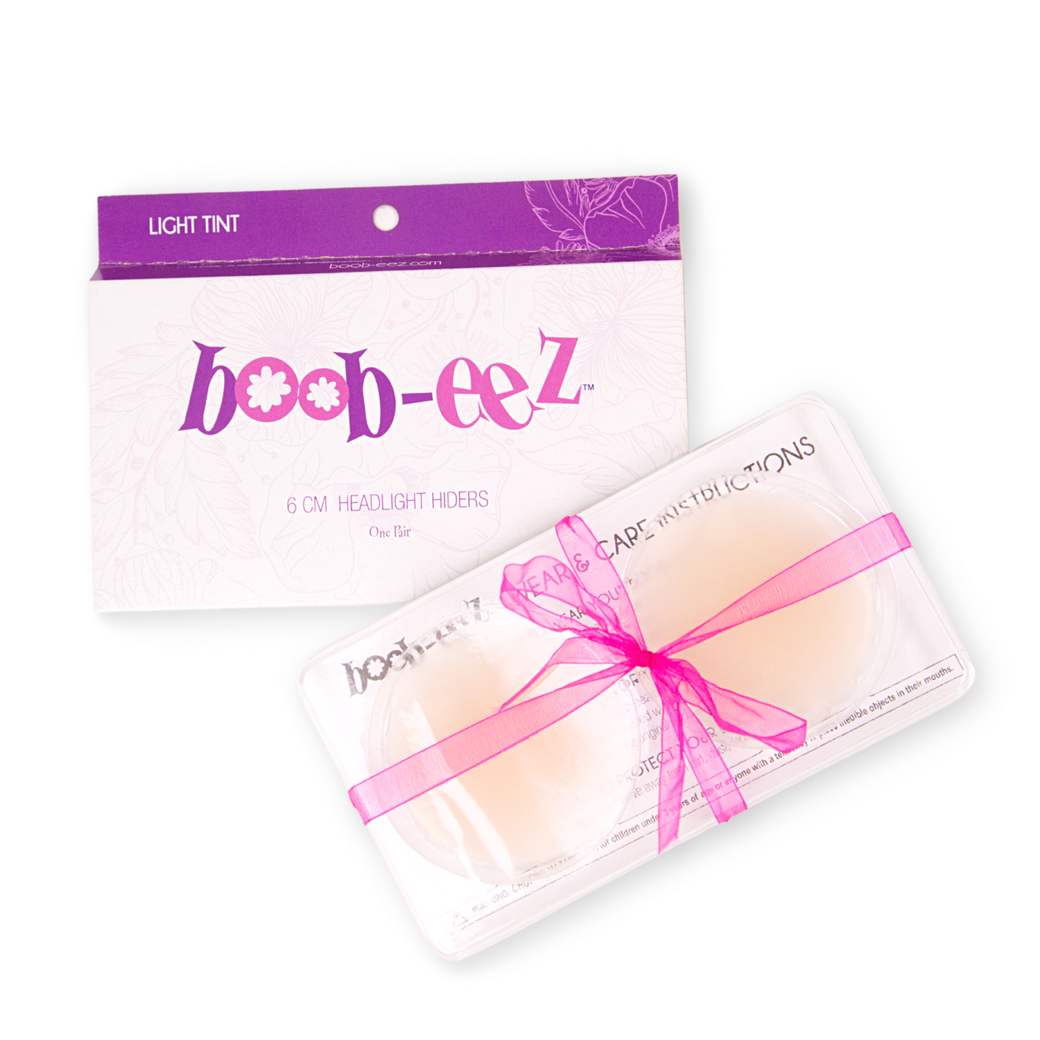 Product shot of reusable Light tint Headlight Hiders size 6cm in recycled craft packaging, including information insert card with wear and care instructions and brand story, close-up shot, against a white background